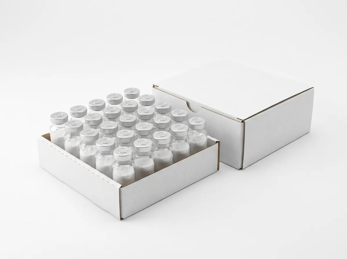 A white tray of twenty lyophilised vials with plain silver crimp caps in a grid, beside a closed white box